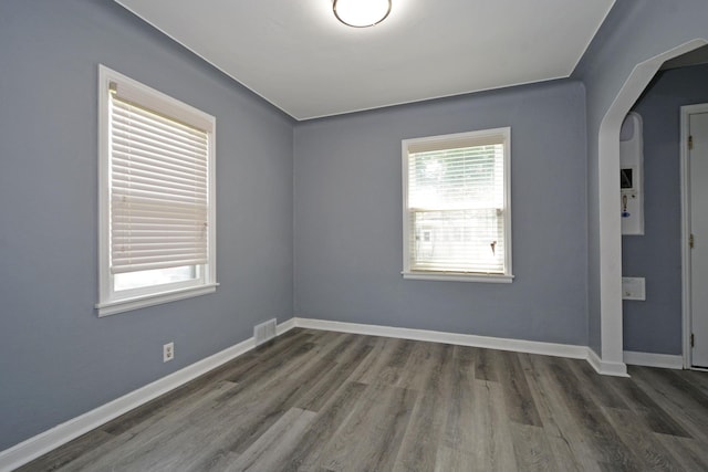 75 Geranium Ave E, Saint Paul, MN 55117 - empty room featuring arched walkways and dark wood-type flooring