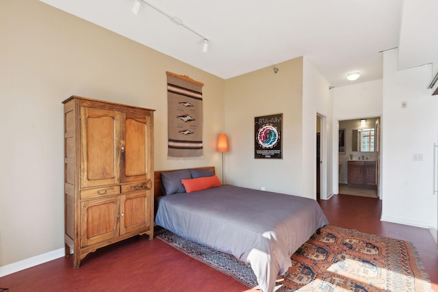 490 Temperance St Unit 403, Saint Paul, MN 55101 - bedroom featuring baseboards, dark wood-style floors, track lighting, and ensuite bath