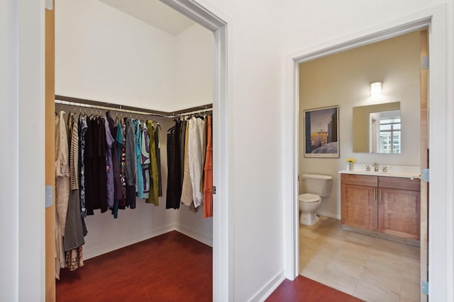 490 Temperance St Unit 403, Saint Paul, MN 55101 - interior space with vanity, baseboards, a spacious closet, and toilet