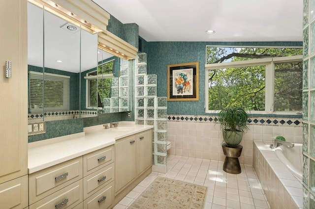 4618 Cedarwood Rd, Saint Louis Park, MN 55416 - full bath featuring tile walls, toilet, vanity, a bath, and tile patterned floors