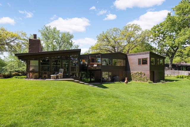 4618 Cedarwood Rd, Saint Louis Park, MN 55416 - back of house featuring a lawn, a chimney, and a patio