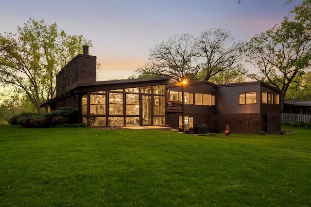 4618 Cedarwood Rd, Saint Louis Park, MN 55416 - back of house with a lawn, a sunroom, and a chimney