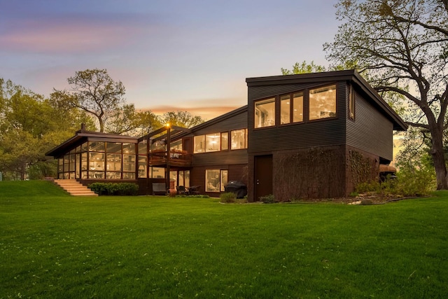 4618 Cedarwood Rd, Saint Louis Park, MN 55416 - back of property with a sunroom and a lawn