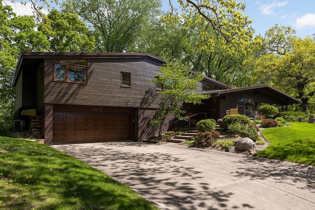 4618 Cedarwood Rd, Saint Louis Park, MN 55416 - view of front facade with driveway, central air condition unit, a garage, and a front yard