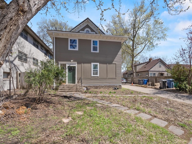 traditional style home featuring fence