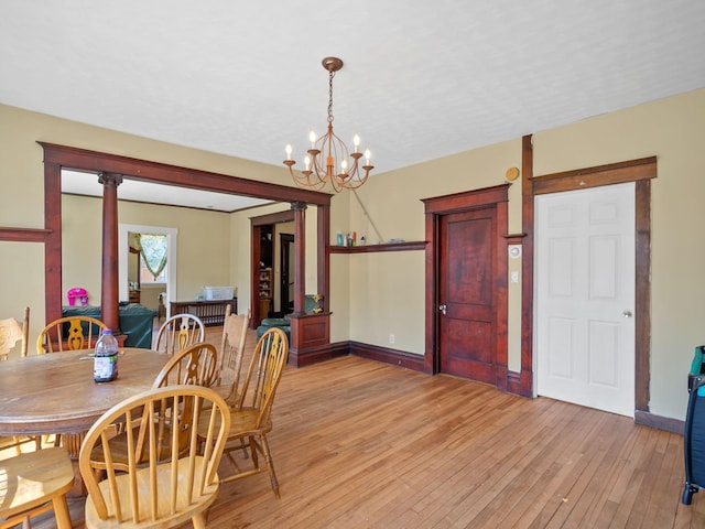 3213 Minnehaha Ave, Minneapolis, MN 55406 - dining room with a chandelier, light wood-type flooring, and baseboards