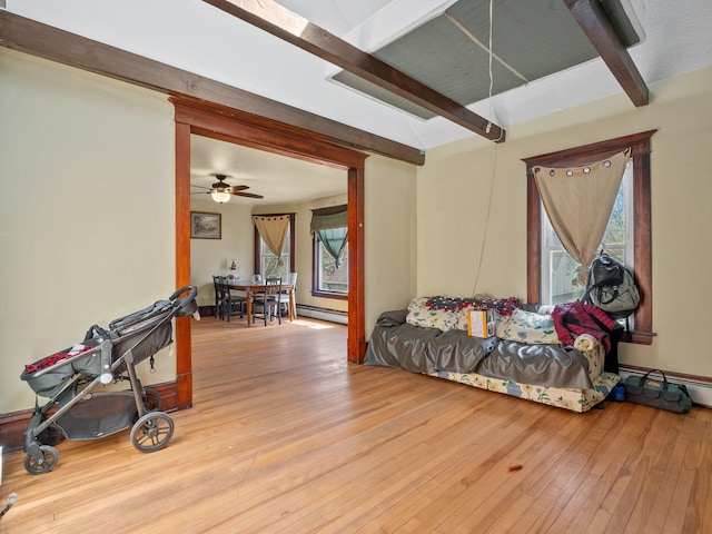 3213 Minnehaha Ave, Minneapolis, MN 55406 - living area featuring beamed ceiling, baseboard heating, and hardwood / wood-style flooring