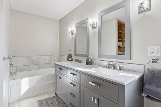 full bathroom featuring double vanity, a sink, tile patterned flooring, and a garden tub