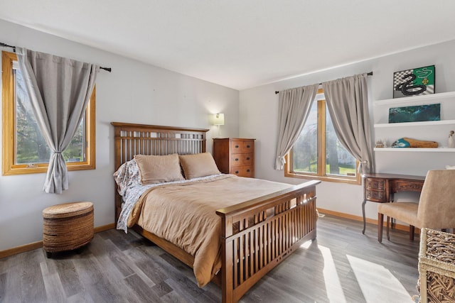bedroom featuring baseboards and wood finished floors