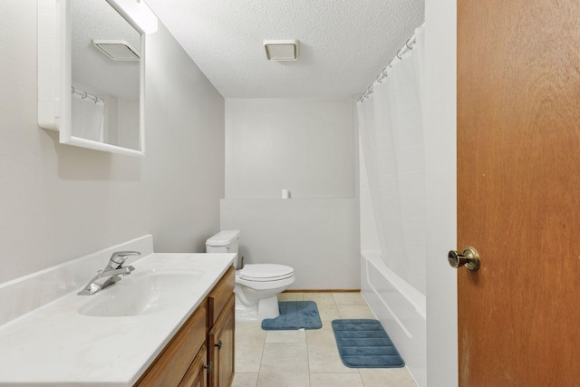 full bath with tile patterned floors, vanity, toilet, and a textured ceiling