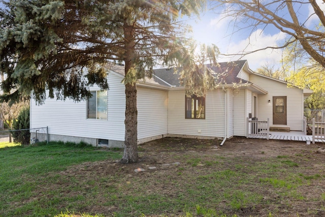 exterior space with fence, a yard, and a deck