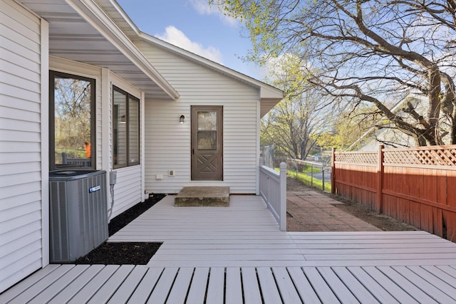 wooden terrace with fence and central AC unit