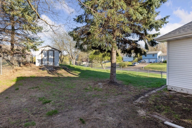 view of yard with a fenced backyard, an outdoor structure, and a shed
