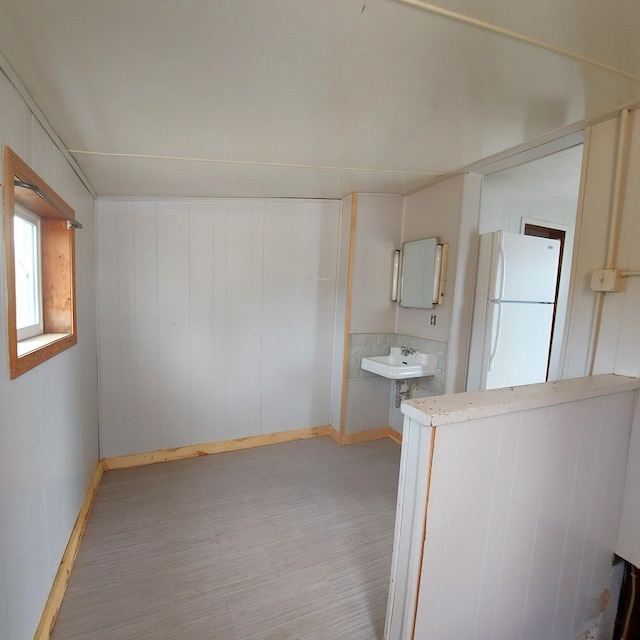 bathroom with baseboards, a sink, and wood finished floors