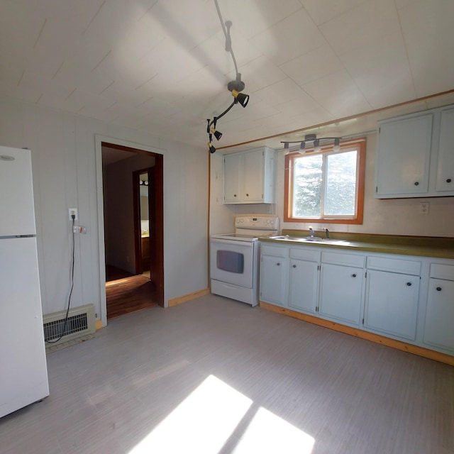 kitchen with visible vents, a sink, light wood-style floors, and white appliances