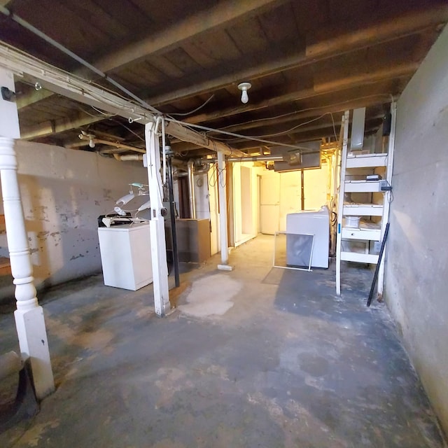 unfinished below grade area featuring washer / dryer