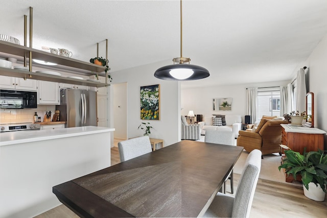 dining room with light wood-style flooring
