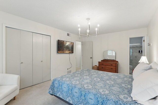bedroom featuring visible vents, a closet, light carpet, connected bathroom, and a chandelier