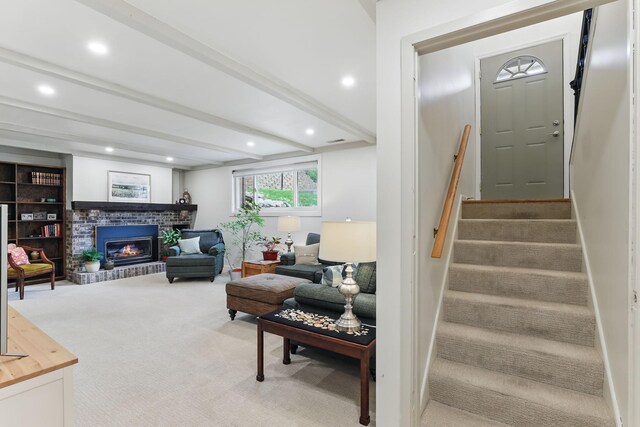 living room featuring stairs, a brick fireplace, beam ceiling, recessed lighting, and carpet flooring