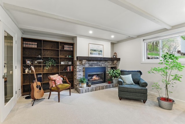 sitting room with a fireplace, carpet floors, recessed lighting, baseboards, and beamed ceiling