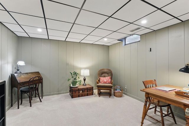 office area with visible vents, a paneled ceiling, and light carpet