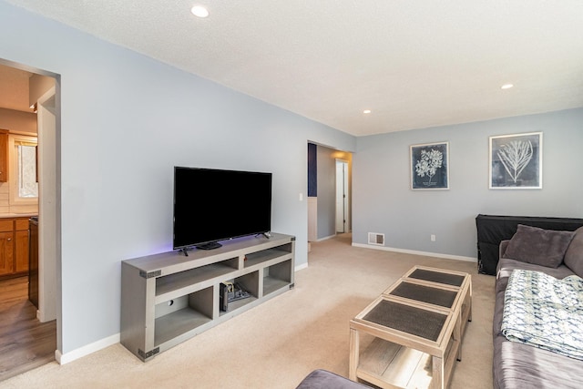 living room with light colored carpet, baseboards, visible vents, and recessed lighting