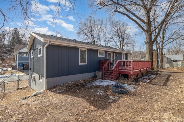 back of house featuring fence and a deck