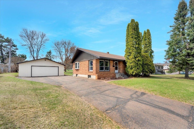 ranch-style home featuring a garage, an outbuilding, and a front yard