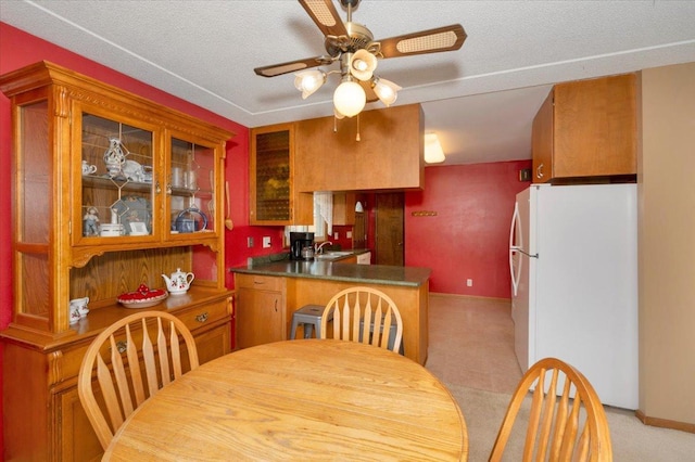 dining space featuring baseboards and ceiling fan