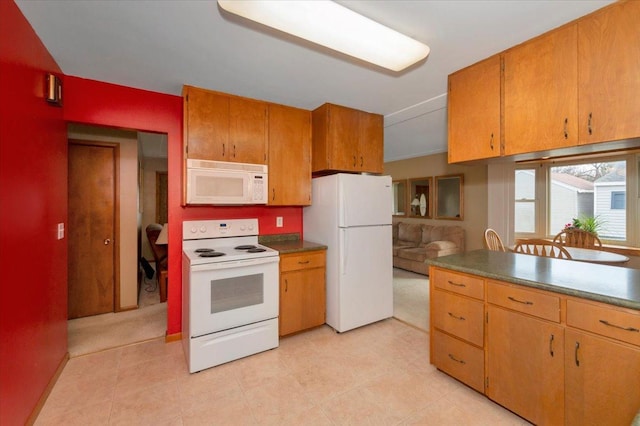kitchen with brown cabinetry and white appliances