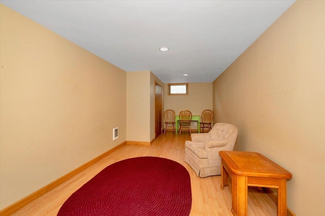 sitting room featuring recessed lighting, baseboards, visible vents, and light wood-type flooring