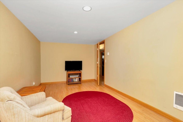living room with recessed lighting, baseboards, and light wood finished floors