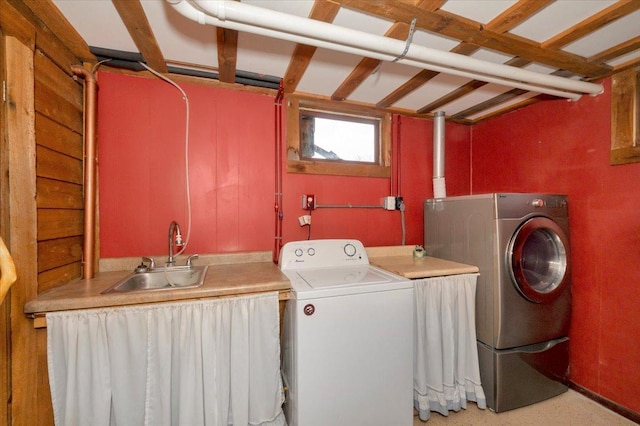 washroom featuring washer and dryer, laundry area, and a sink