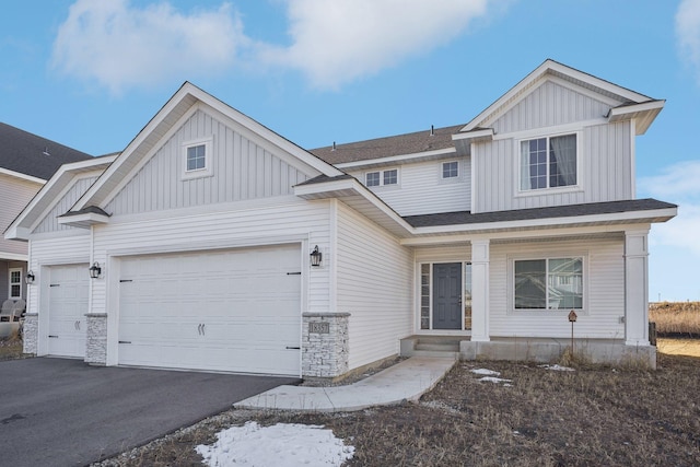 18357 Glacier Way, Lakeville, MN 55044 - view of front of property with a shingled roof, board and batten siding, an attached garage, and driveway