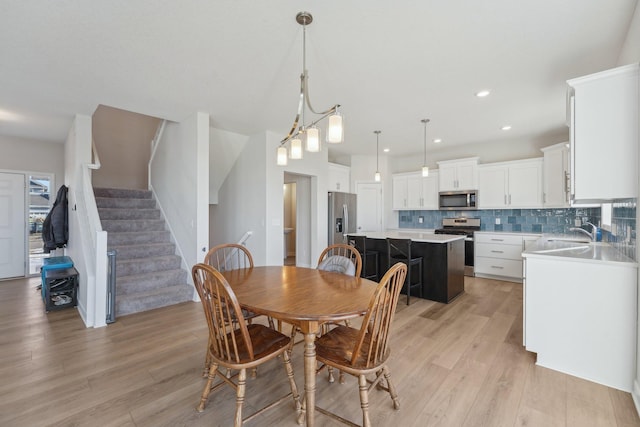 18357 Glacier Way, Lakeville, MN 55044 - dining space featuring recessed lighting, light wood finished floors, and stairs