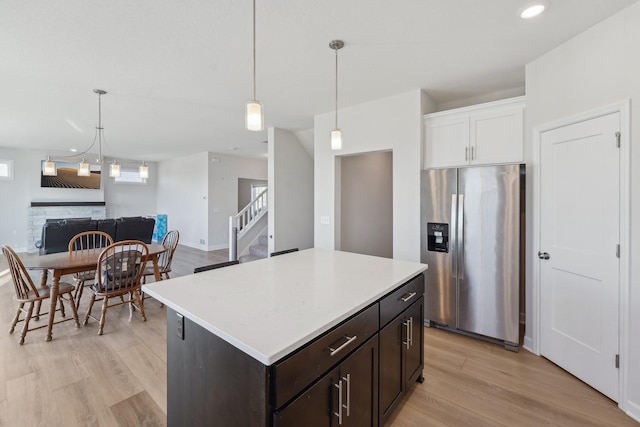 18357 Glacier Way, Lakeville, MN 55044 - kitchen featuring dark brown cabinetry, stainless steel refrigerator with ice dispenser, light countertops, light wood finished floors, and white cabinetry