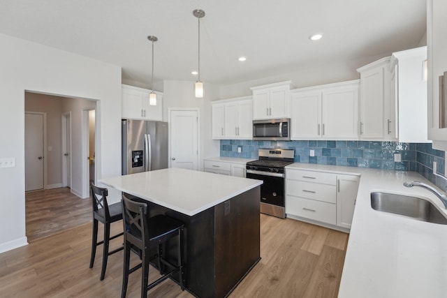 18357 Glacier Way, Lakeville, MN 55044 - kitchen featuring a kitchen island, appliances with stainless steel finishes, decorative backsplash, and a sink