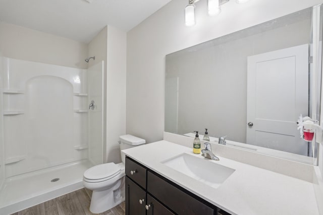 18357 Glacier Way, Lakeville, MN 55044 - bathroom featuring vanity, walk in shower, wood finished floors, and toilet