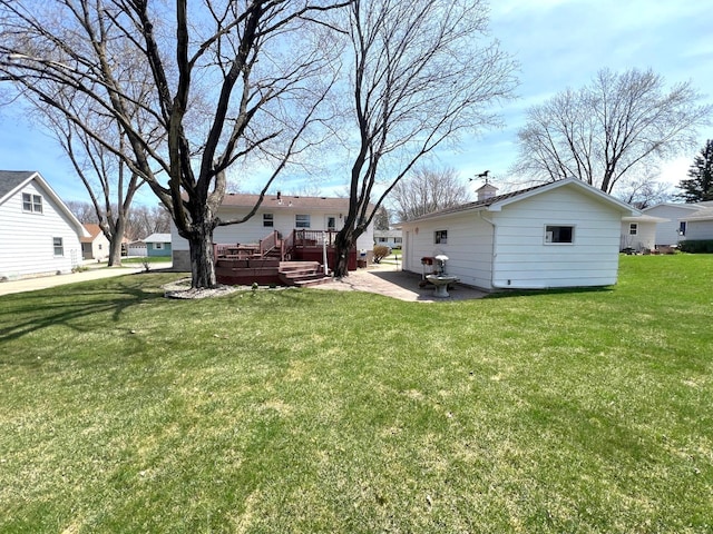 view of green lawn featuring a deck