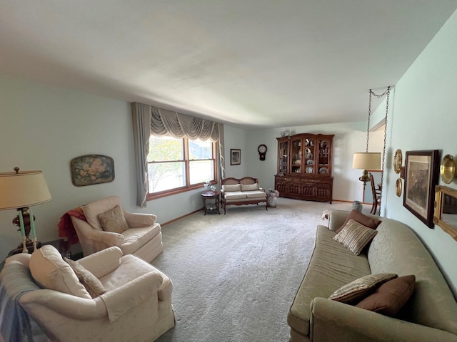 carpeted living area featuring baseboards