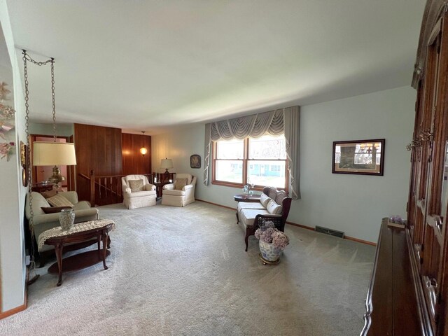 living area featuring carpet and baseboards