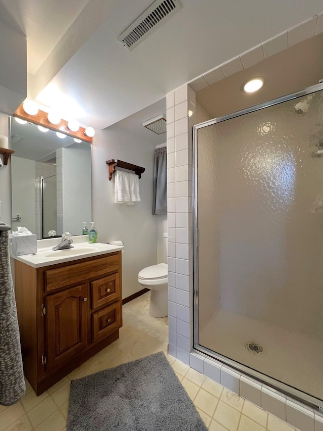 full bathroom featuring tile patterned floors, a shower stall, vanity, and toilet