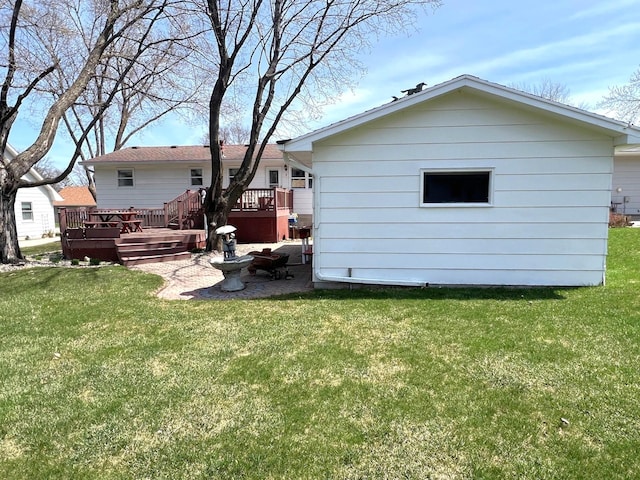 back of house with a wooden deck and a yard