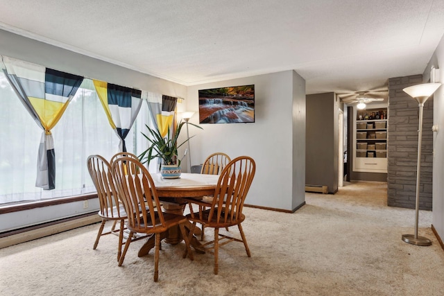 carpeted dining area featuring a ceiling fan, baseboards, a textured ceiling, and a baseboard radiator
