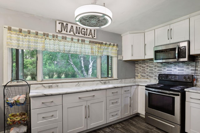 kitchen with decorative backsplash, white cabinets, appliances with stainless steel finishes, and a wealth of natural light