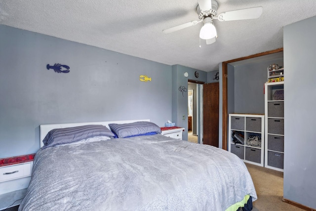 carpeted bedroom with a ceiling fan and a textured ceiling