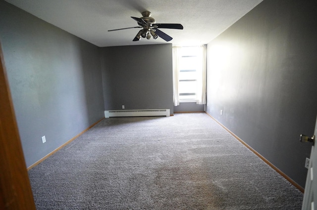 spare room with baseboards, a baseboard radiator, a ceiling fan, and carpet flooring