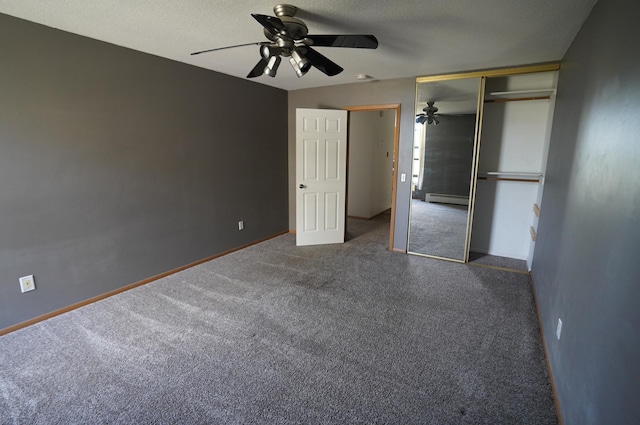 unfurnished bedroom with ceiling fan, a textured ceiling, baseboard heating, baseboards, and carpet
