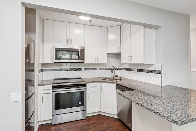 2110 Ridge Dr Unit 11, Saint Louis Park, MN 55416 - kitchen featuring appliances with stainless steel finishes, a sink, a peninsula, white cabinets, and light stone countertops