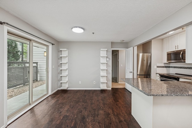 2110 Ridge Dr Unit 11, Saint Louis Park, MN 55416 - kitchen featuring appliances with stainless steel finishes, dark wood-style floors, dark stone countertops, white cabinetry, and a textured ceiling